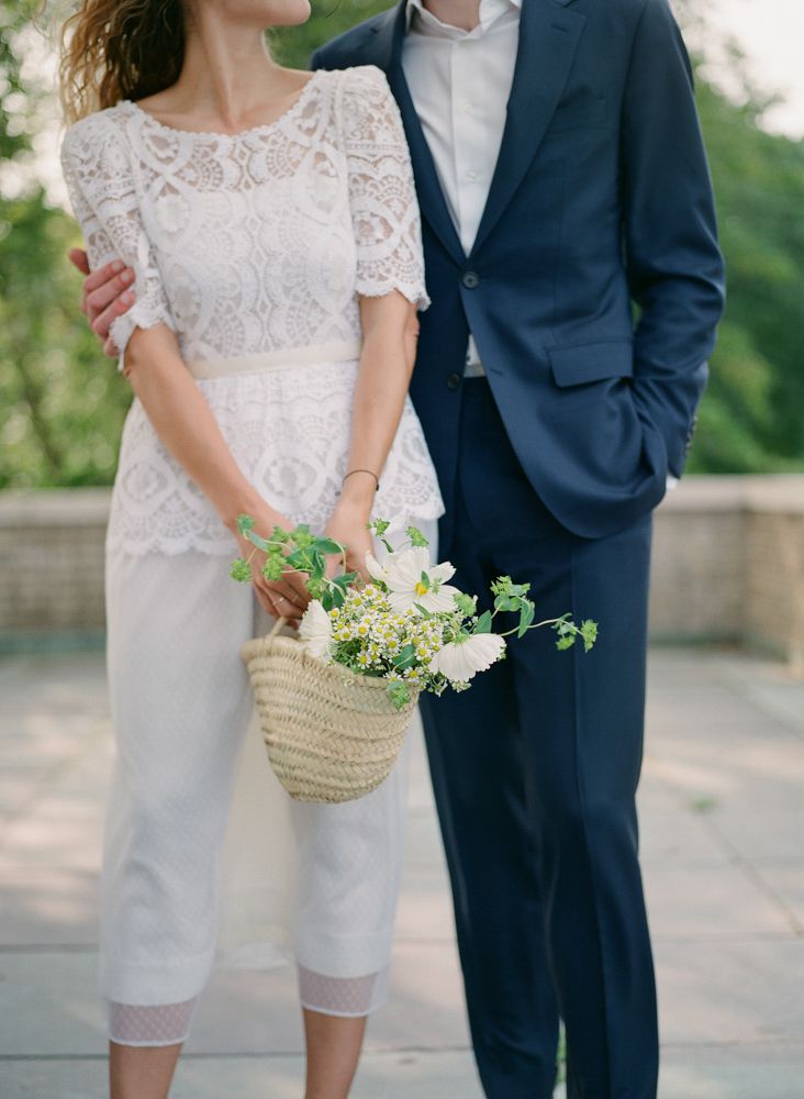 bride and groom with wedding bouquet in basket