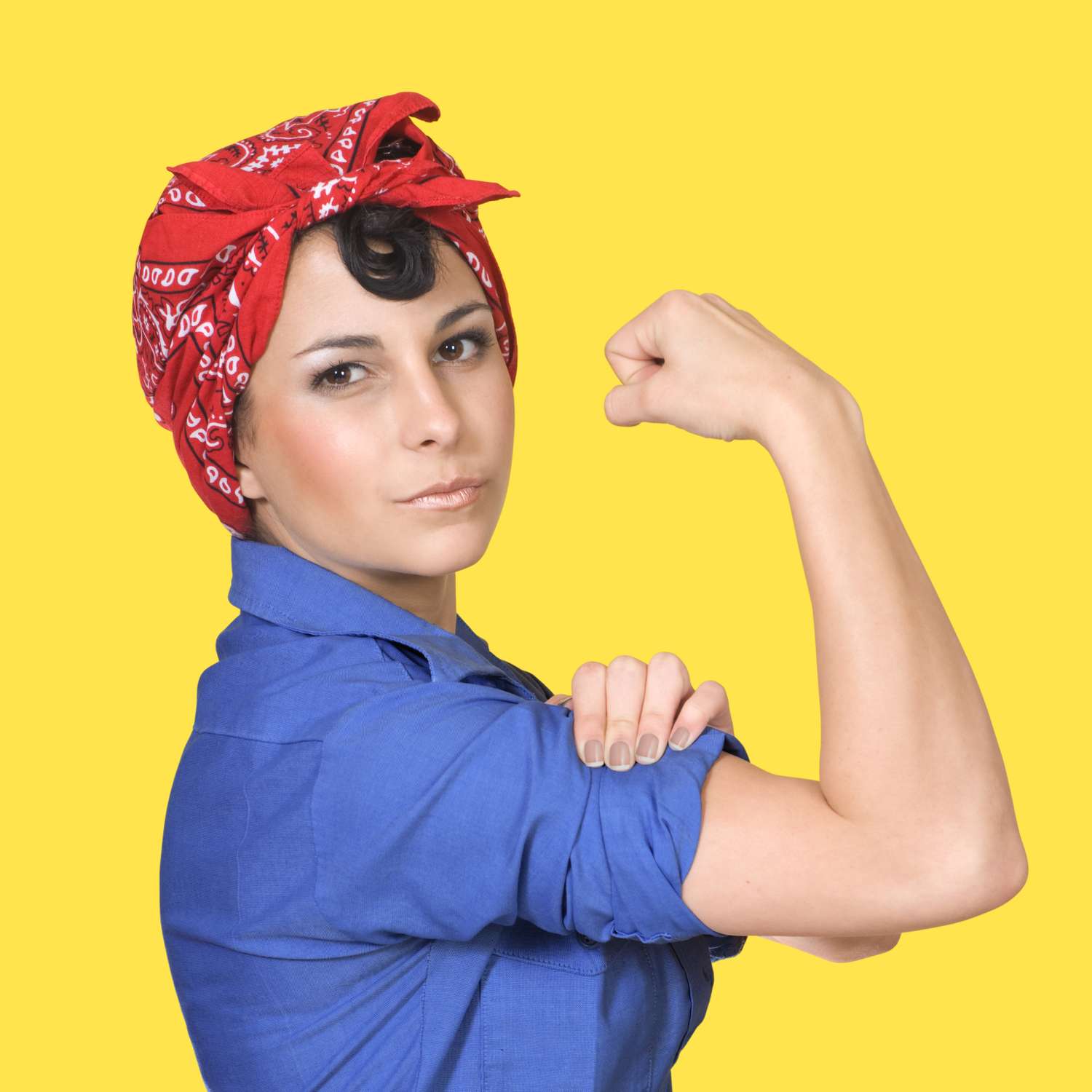 A person poses in a style reminiscent of the Rosie the Riveter poster showing a confident expression and flexing their arm