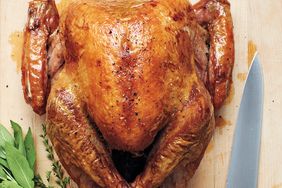 roasted turkey on wood cutting board