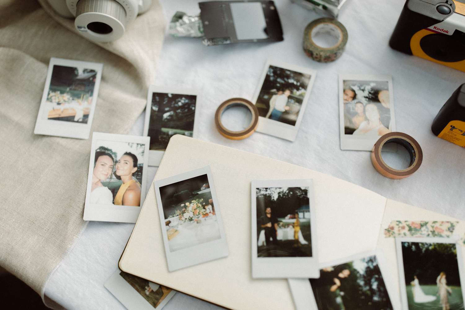 various polaroid photos laid out on table