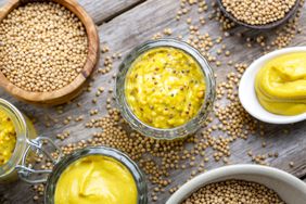types of mustard and mustard seeds on rustic wood surface 