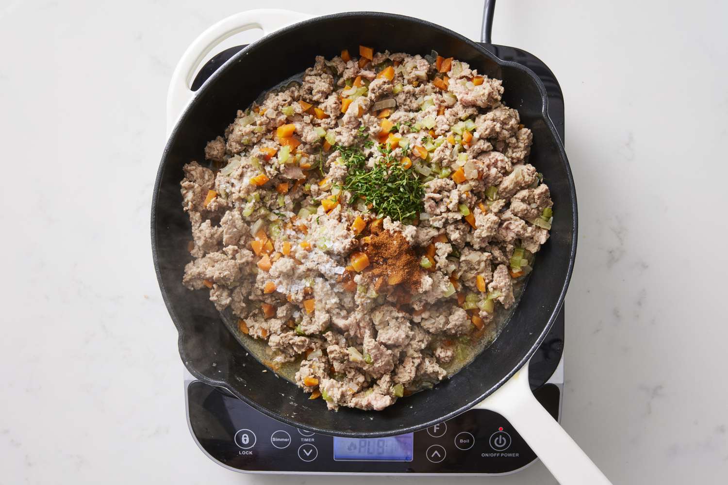 Seasoned ground turkey shepards pie mixture in skillet