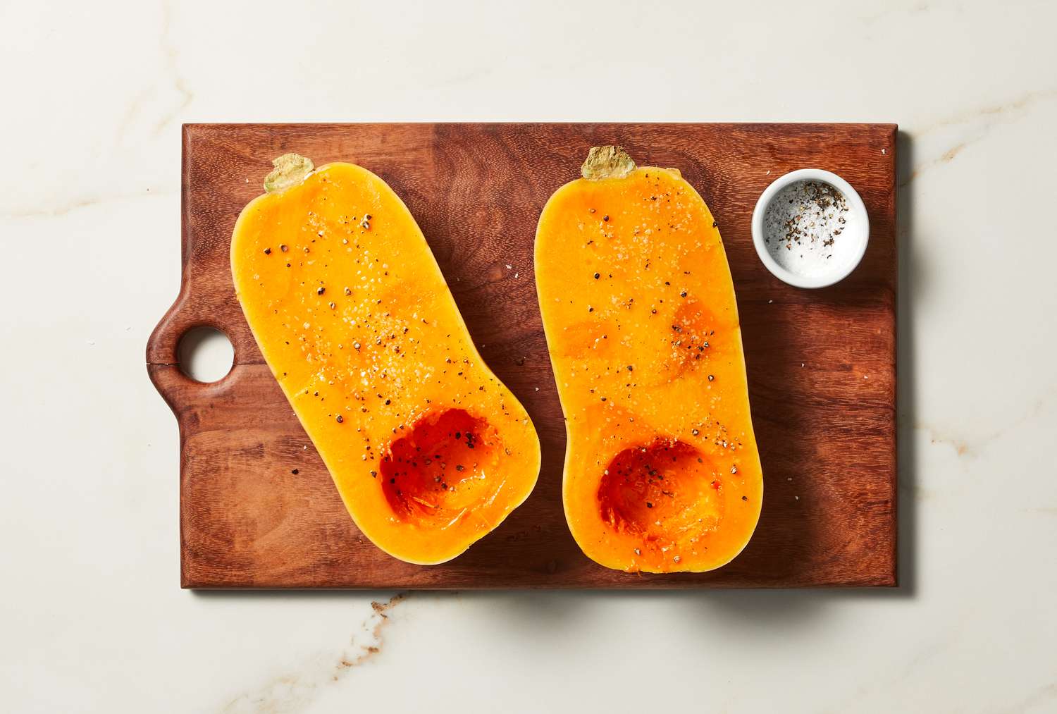 overhead view of cooked butternut squash on a cutting board