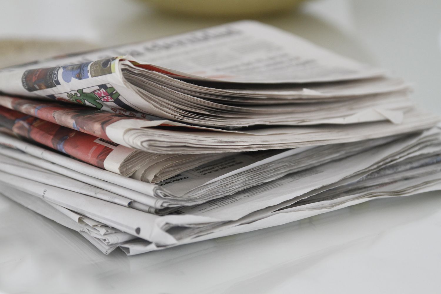 Stack of folded newspapers on a table