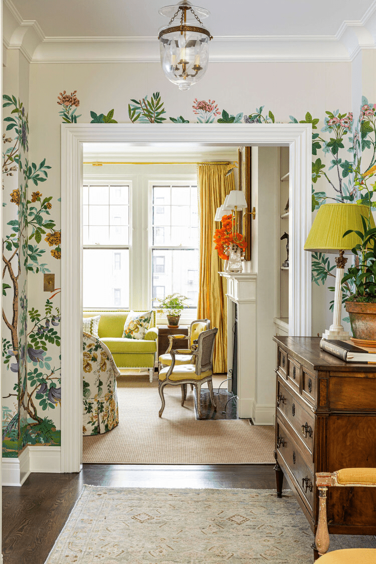 hallway with floral wallpaper and bright yellow pops of color