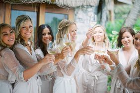 wedding bridal party getting ready and toasting white