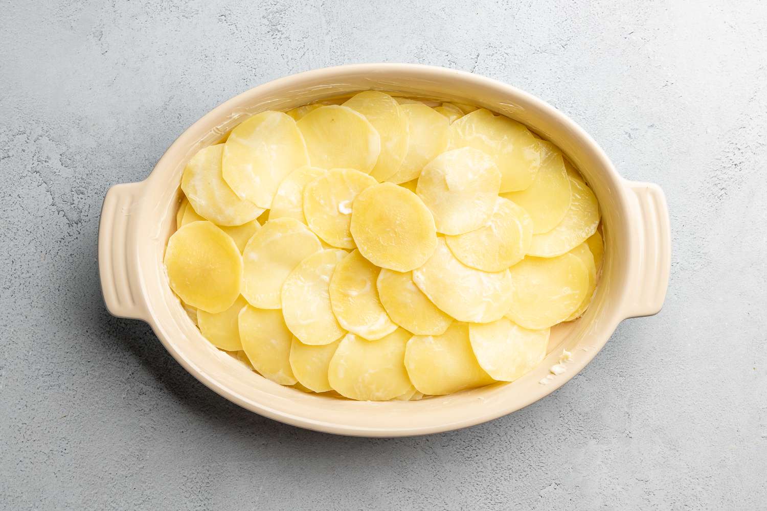 cooked sliced potatoes in baking dish for scalloped potatoes