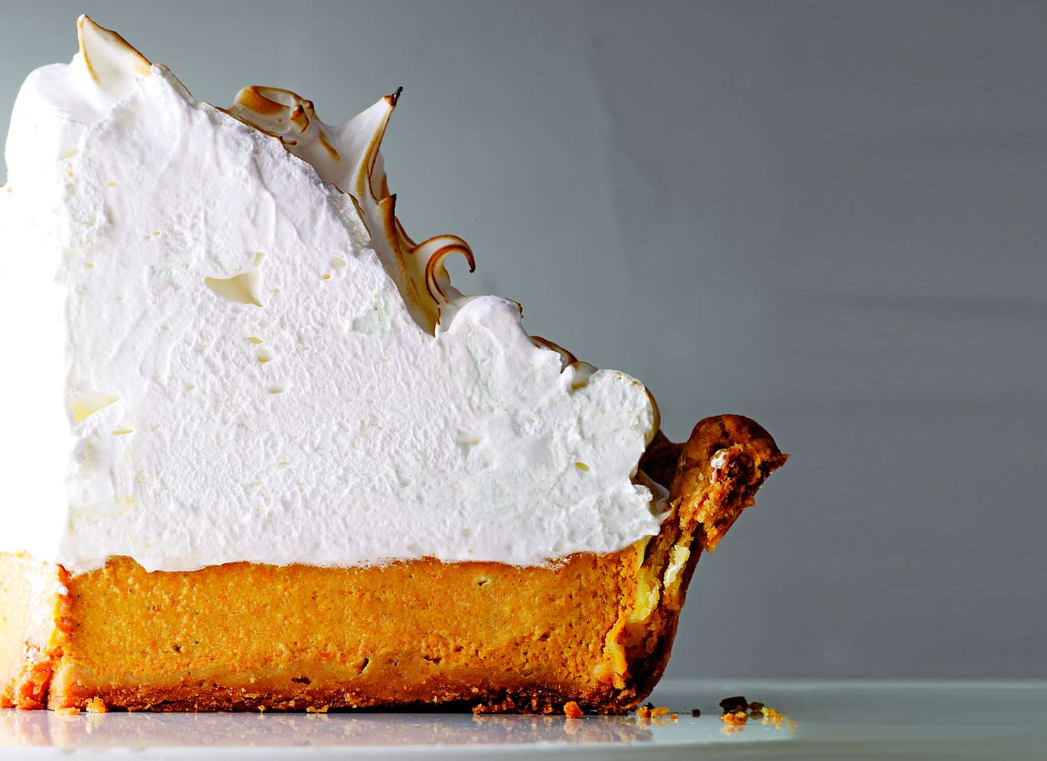 close up of pumpkin pie with lots of meringue