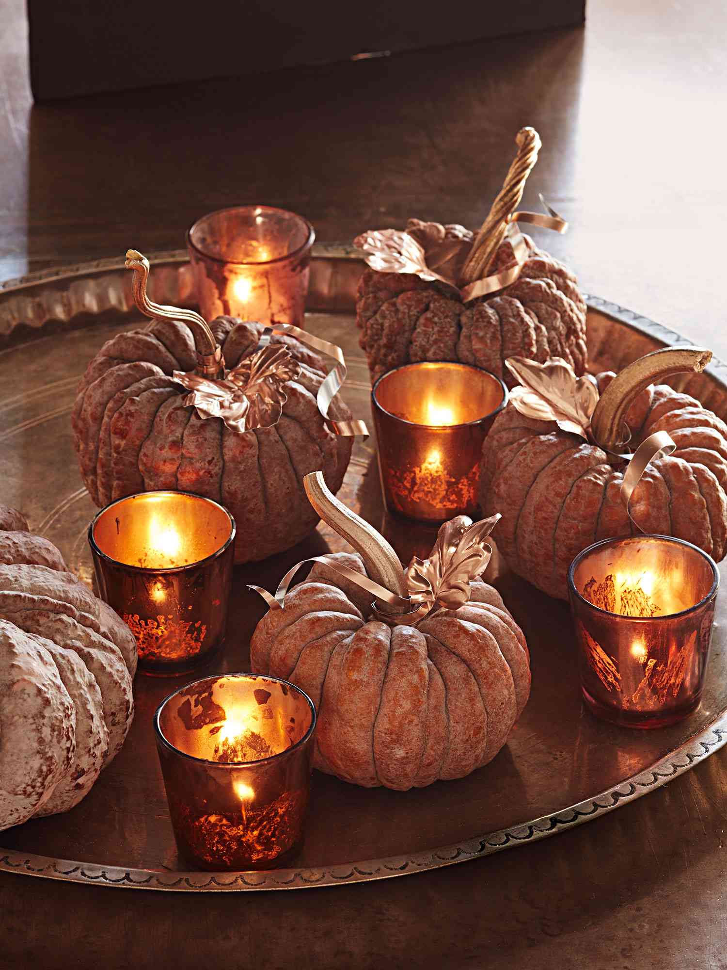 Thanksgiving centerpiece with votive candles and pumpkins