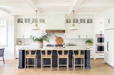 expansive white kitchen with wooden and navy accents