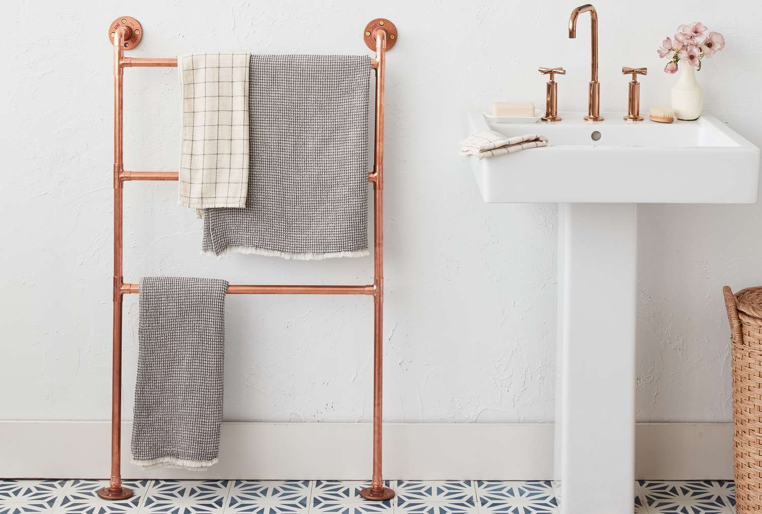 Bathroom decor including a towel rack and a sink with accessories