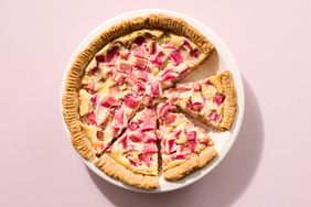 Sliced rhubarb and custard pie on a white plate
