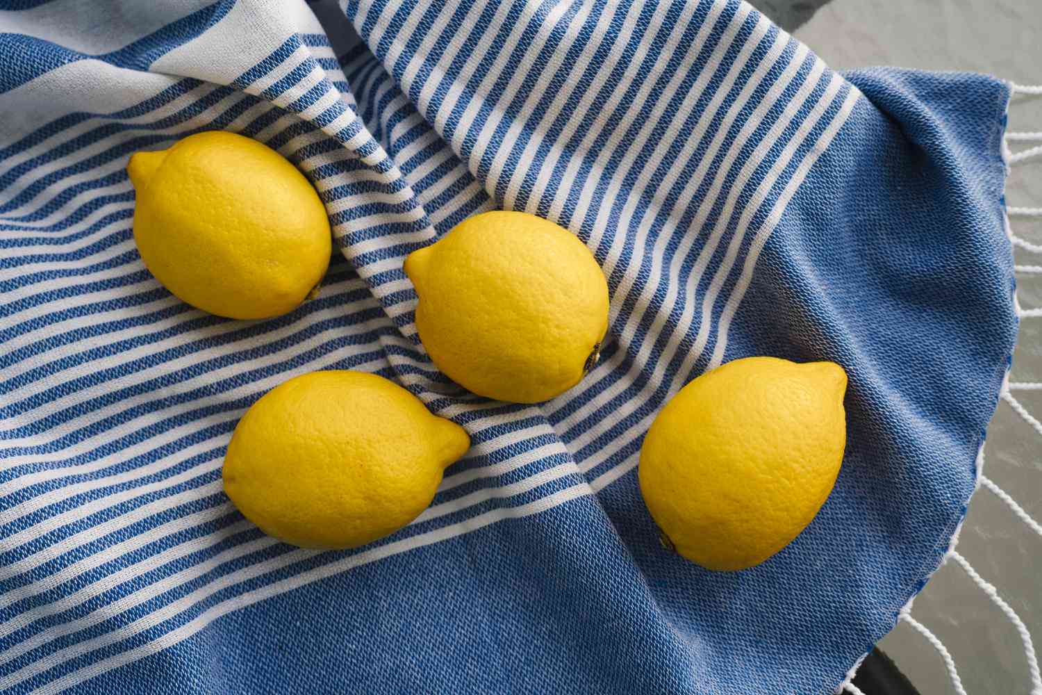 4 lemons on blue and white striped cloth