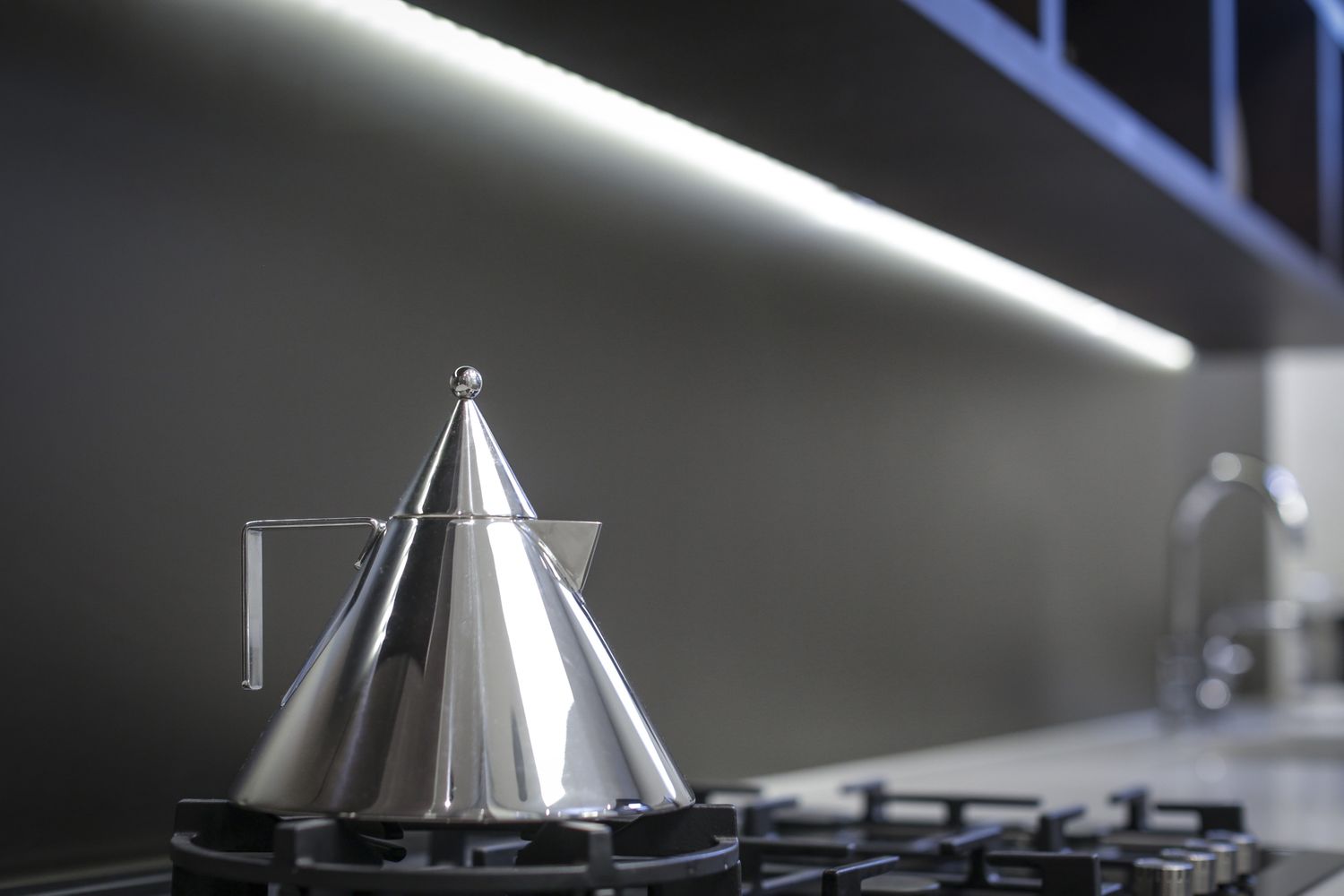 A modern kettle on a stovetop part of a sleek kitchen design