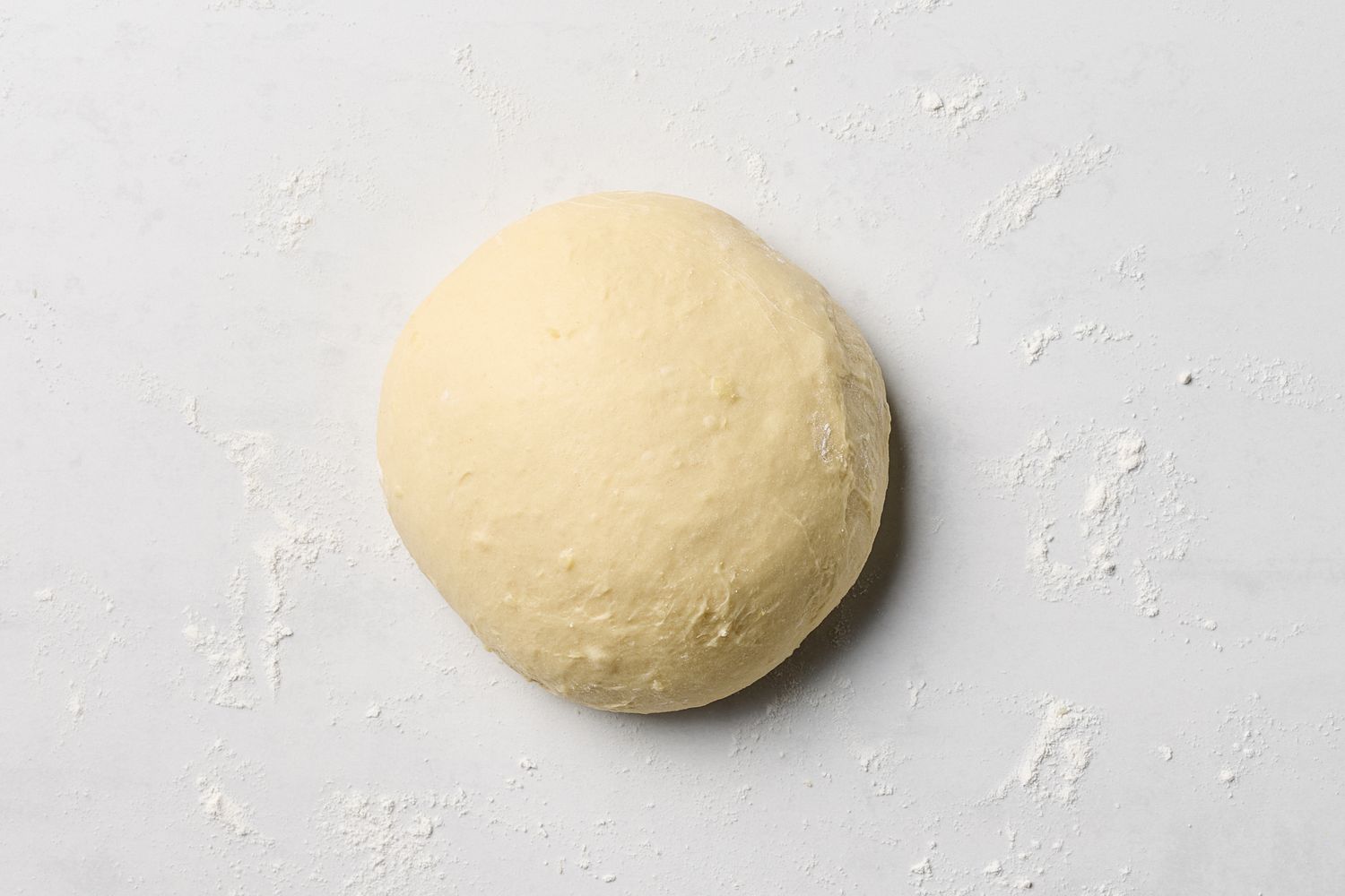 A ball of dough on a floured surface
