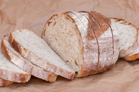 A loaf of sliced bread arranged on brown paper