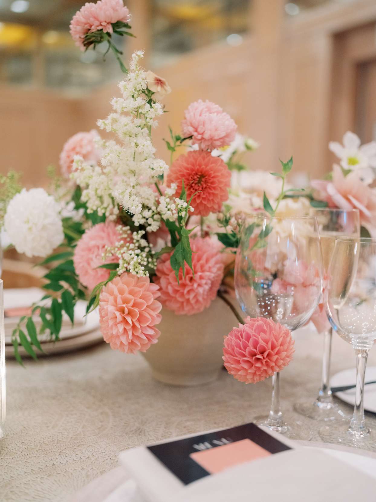 wedding centerpiece with dahlias, roses, and cascading veronica flowers