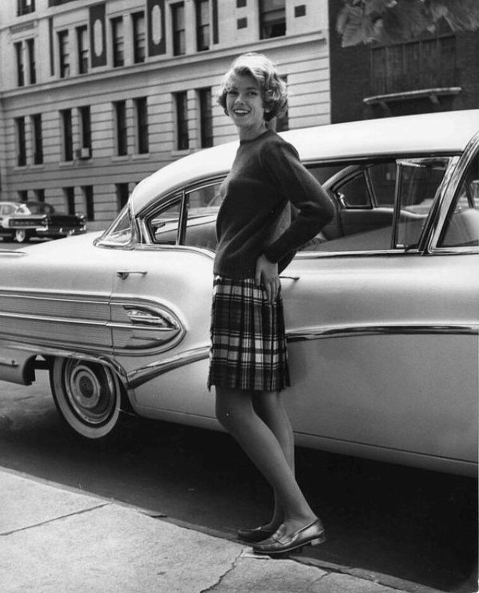 martha standing in front of car during college days