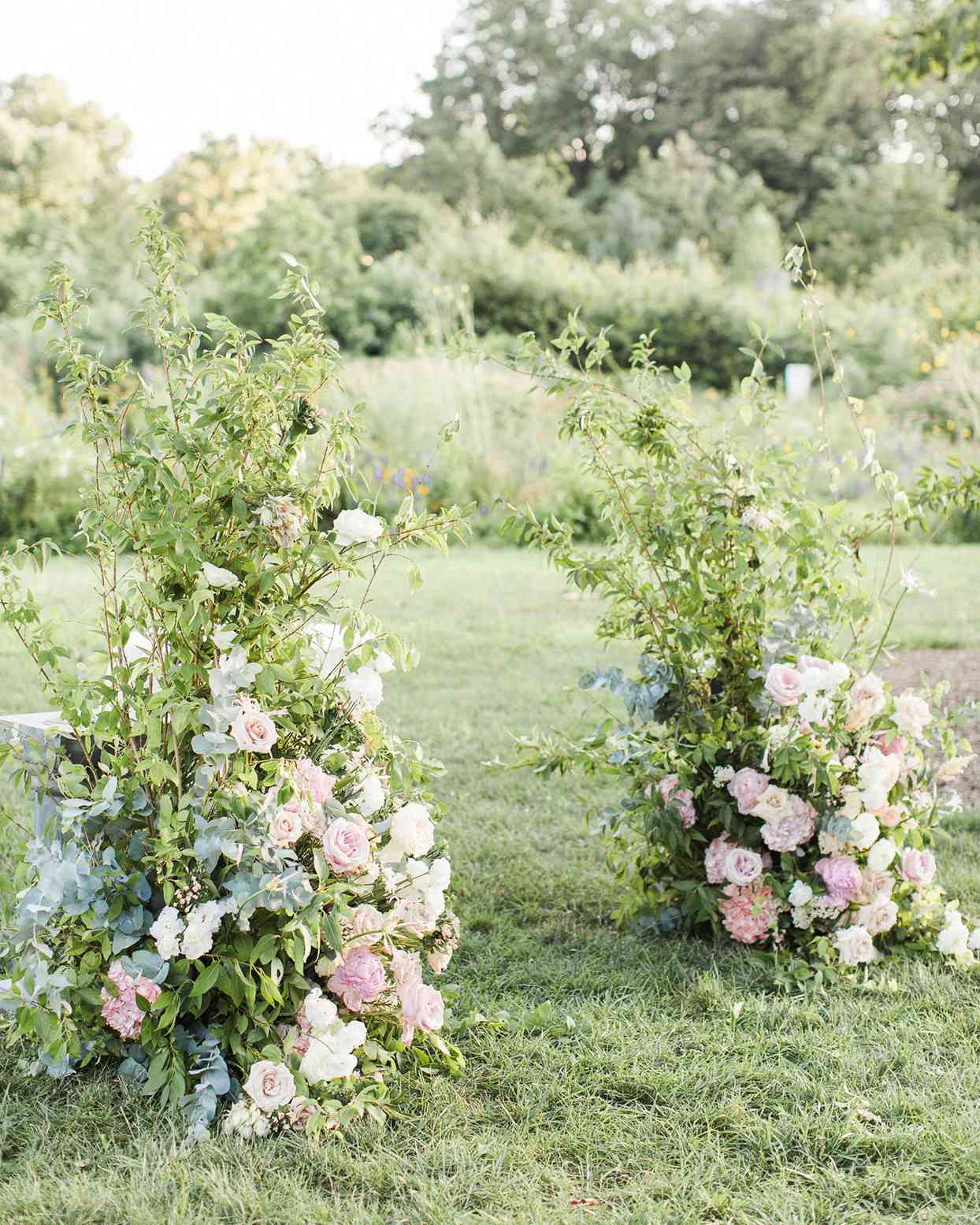 grace john wedding ceremony floral arrangements creating ceremony arch in grass