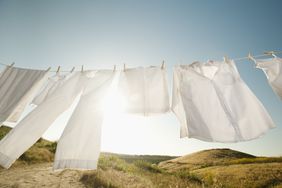 Clothes hanging on a line outdoors in a sunny rural landscape