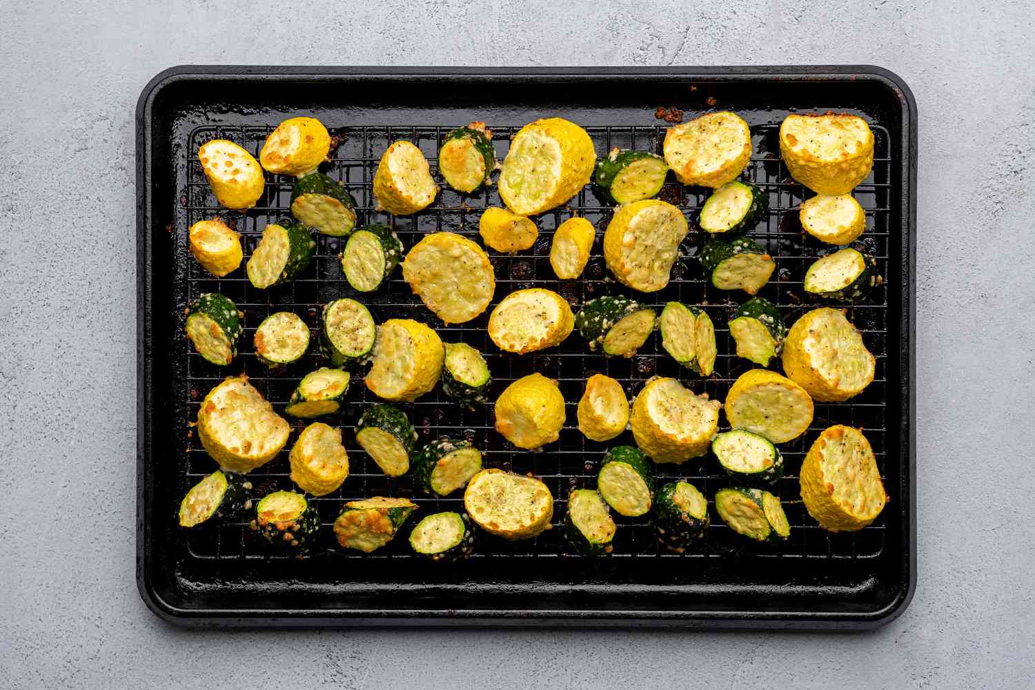 roasted summer squash and zucchini on a rack set over a baking sheet
