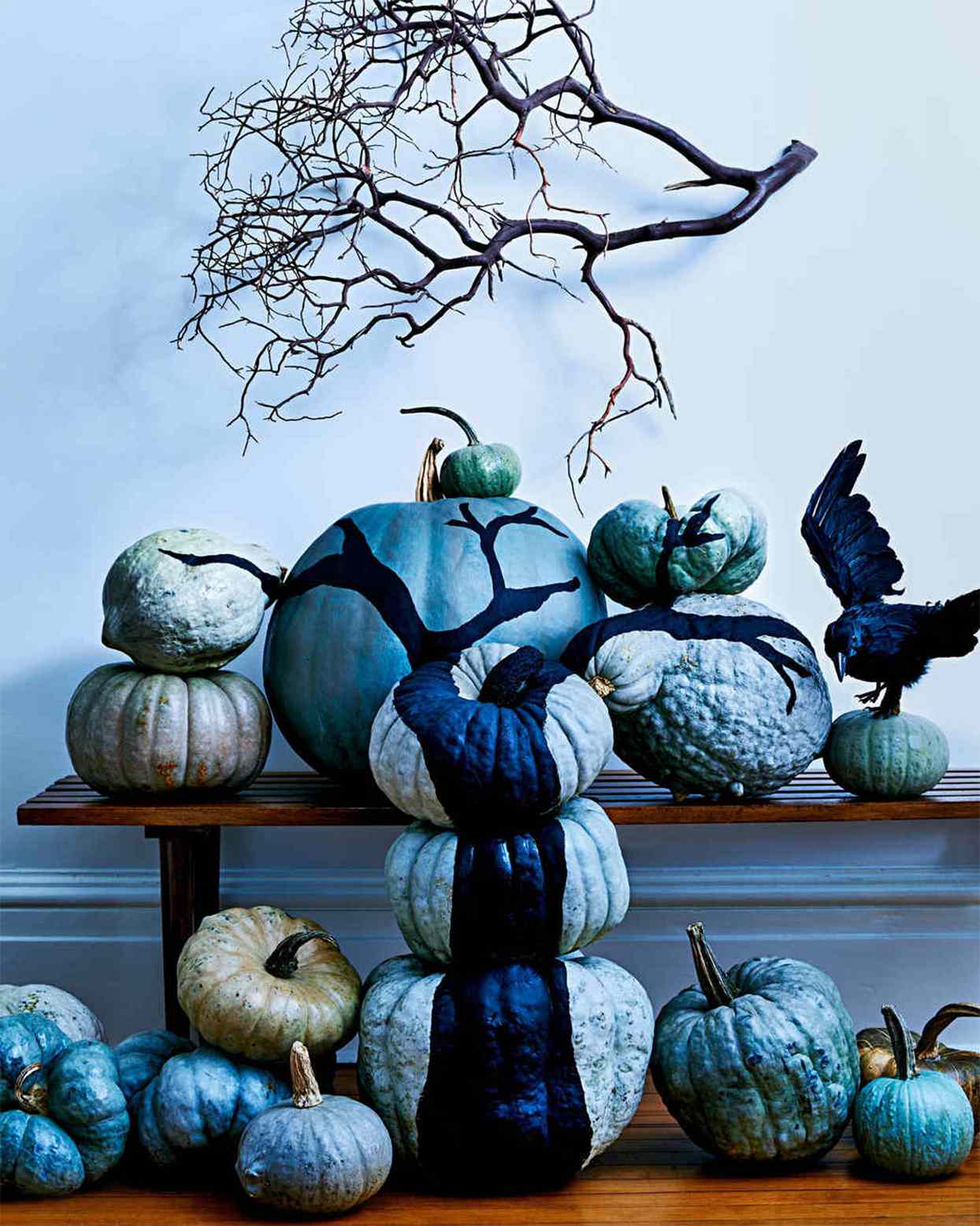 painted pumpkins stacked to form a tree