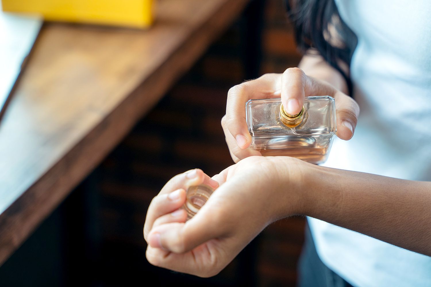 Person applying perfume to wrist