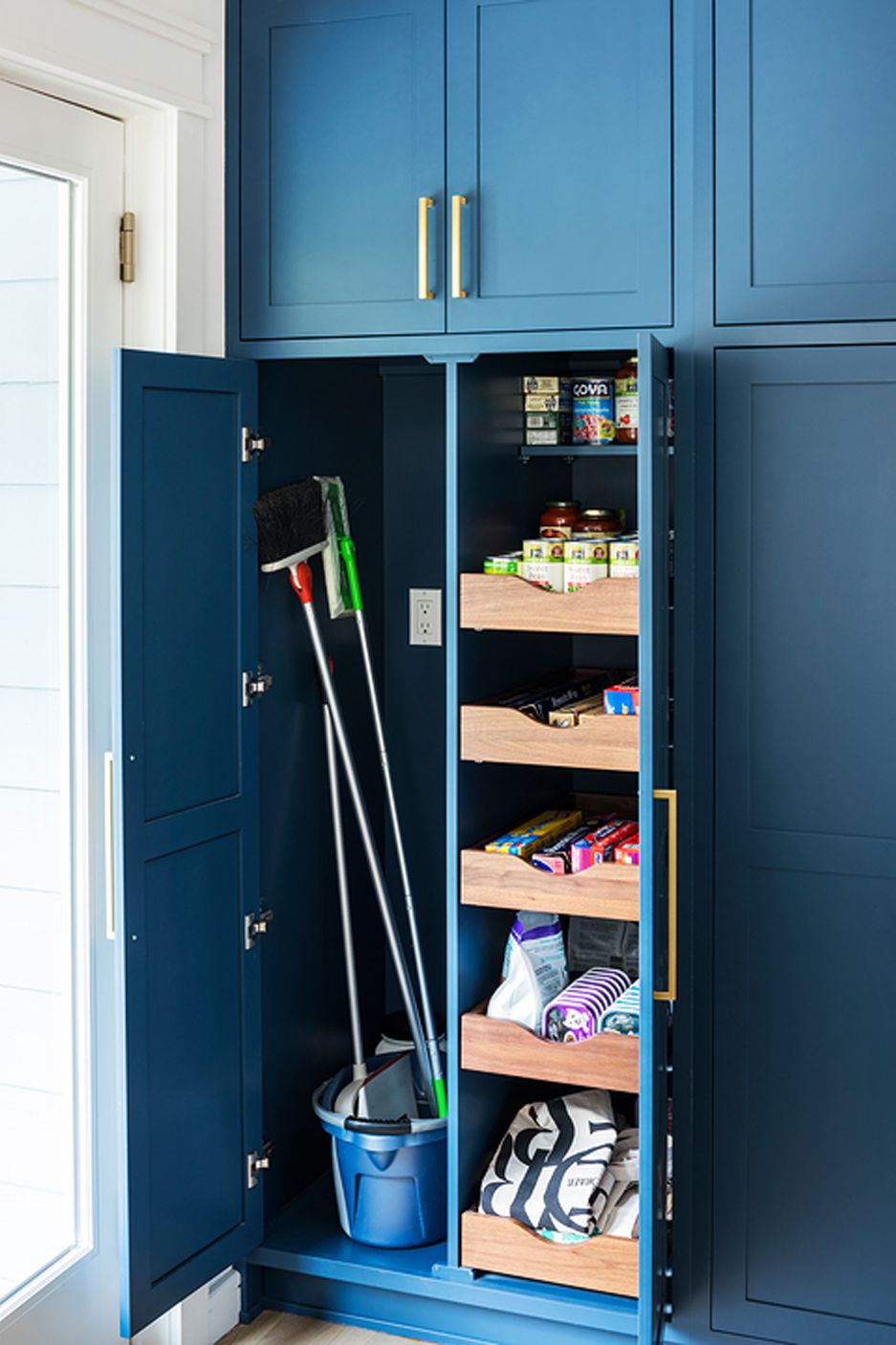 pantry organization broom closet and drawers in blue kitchen