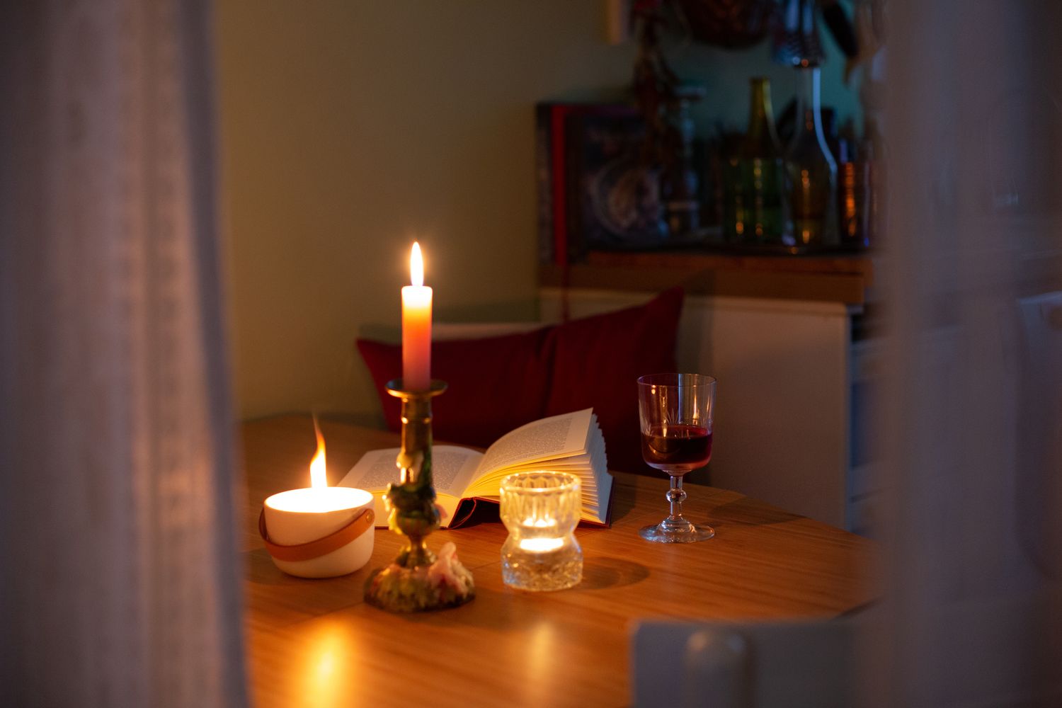 A book illuminated by candlelight on kitchen table during power outage
