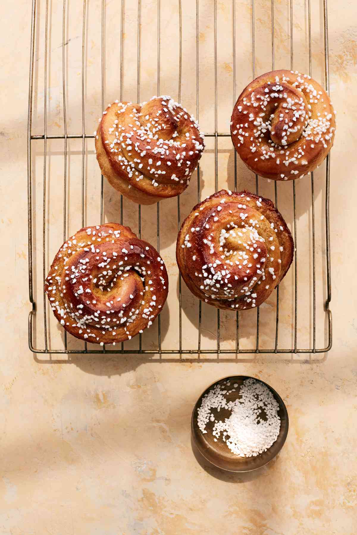 orange cardamom morning buns on cooling rack topped with sanding sugar
