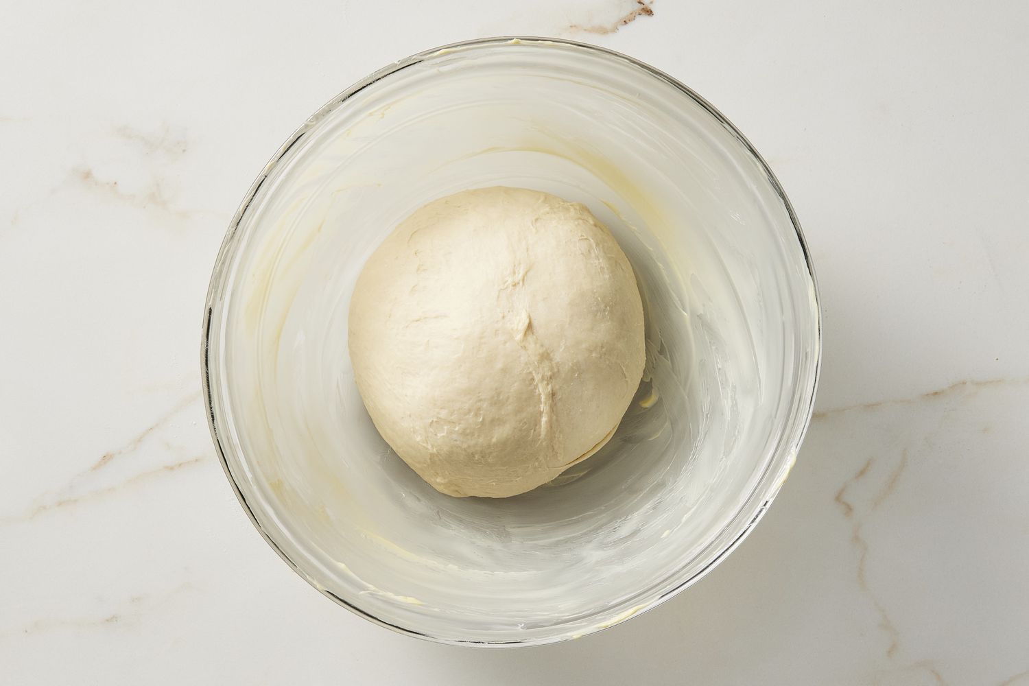 Dough ball in glass bowl
