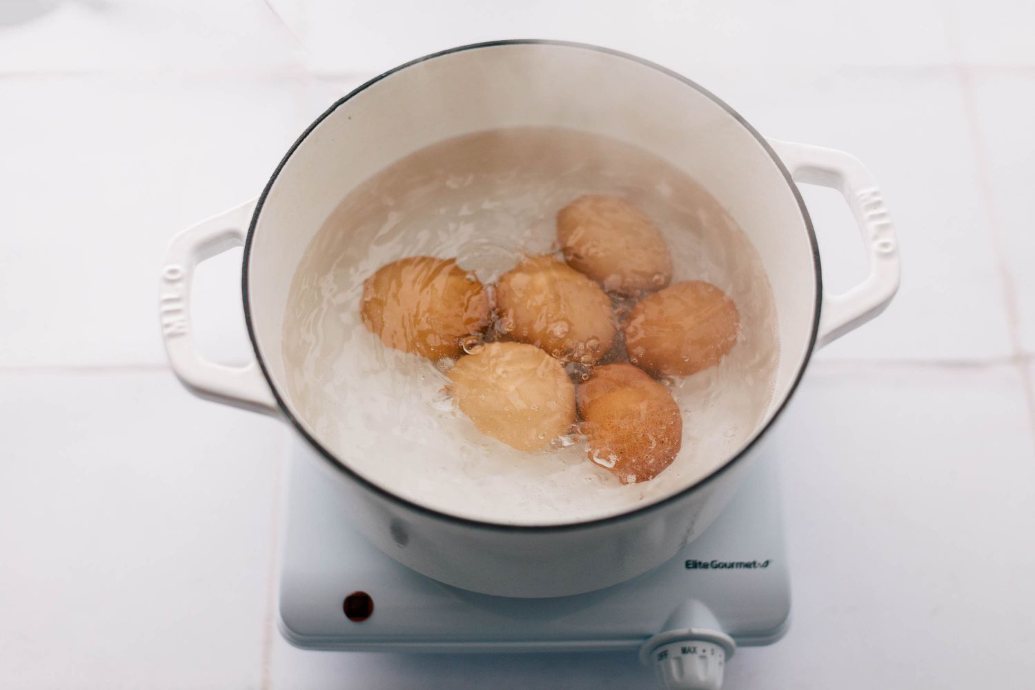 Boiling eggs in pot of water