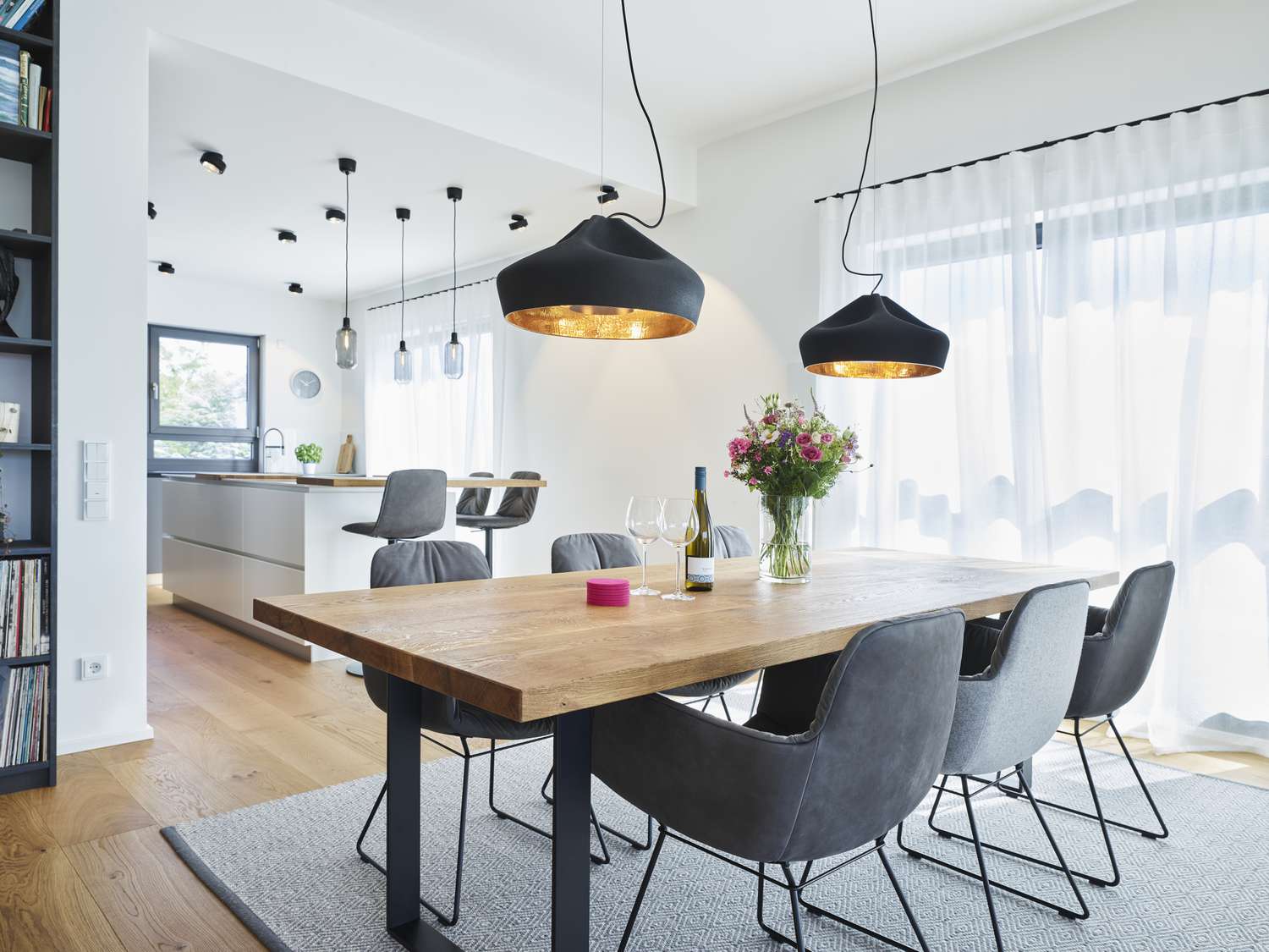 white dining room with pendant lights