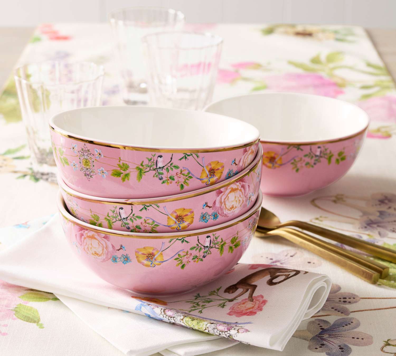 pink cereal bowls against a floral tablescape