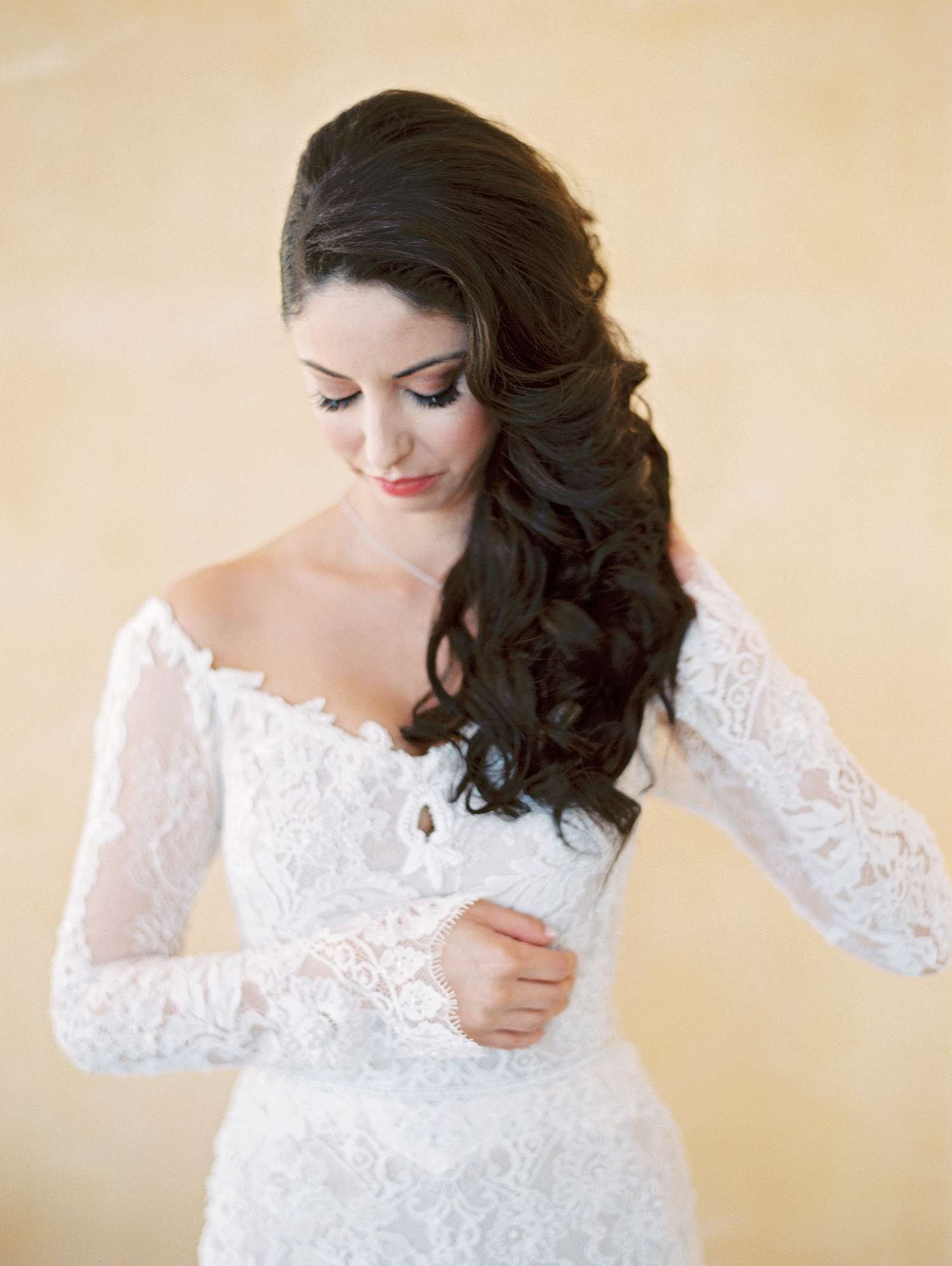 bride with off-the-shoulder dress and side-swept hair