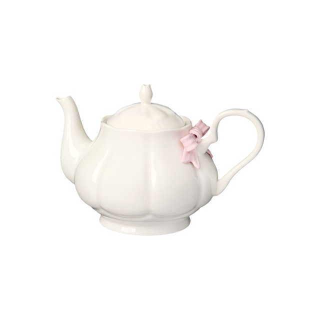A ceramic teapot with a decorative pink bow on the handle