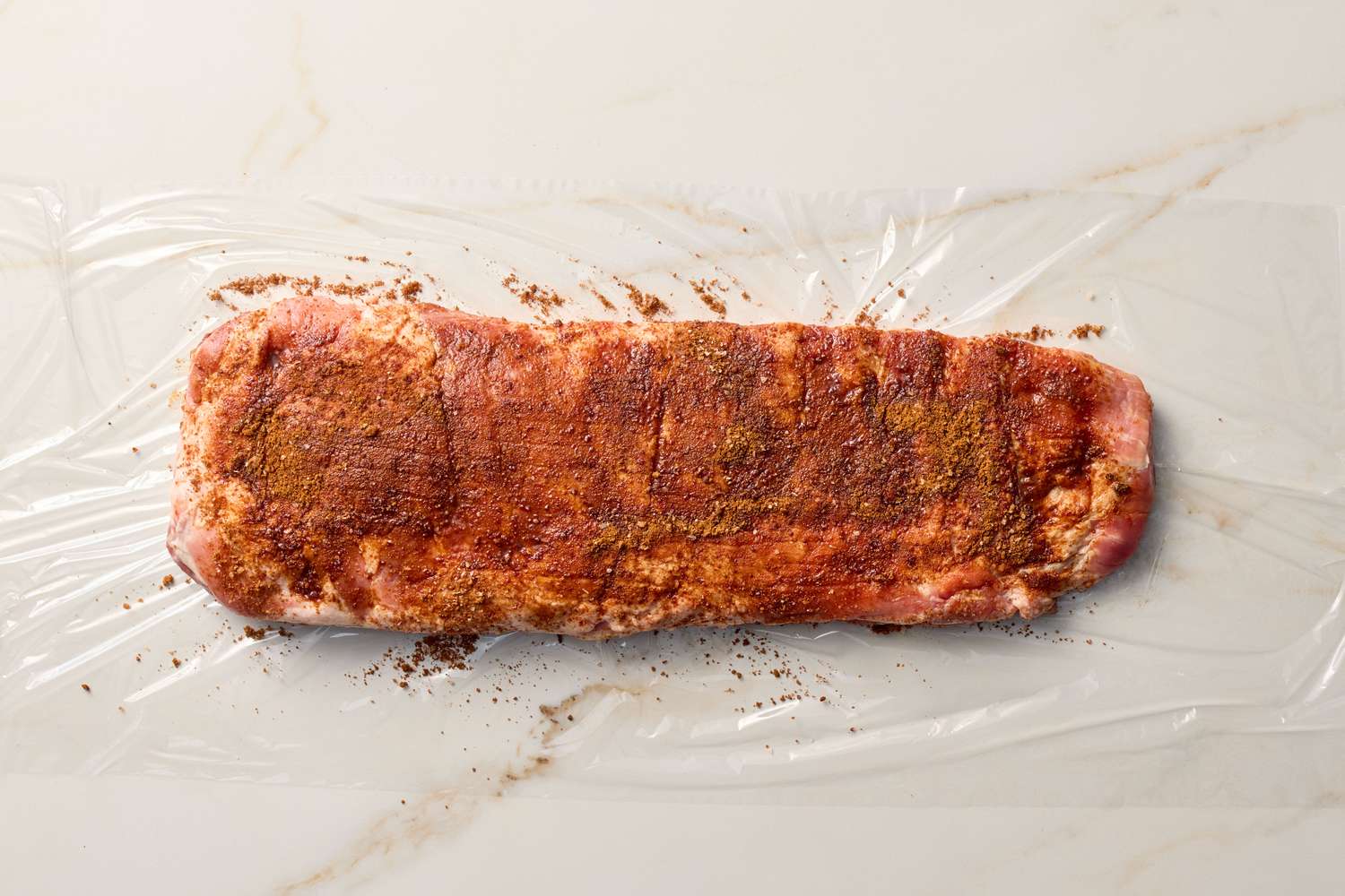 Rack of ribs seasoned and ready for barbecuing