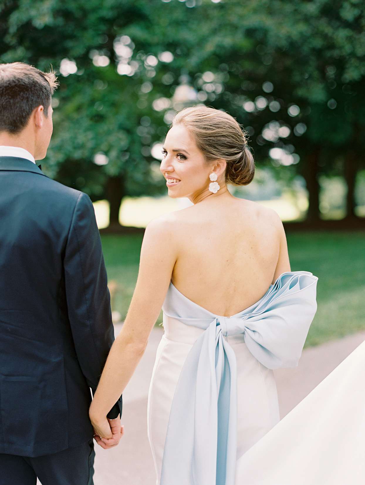 bride and groom holding hands outside