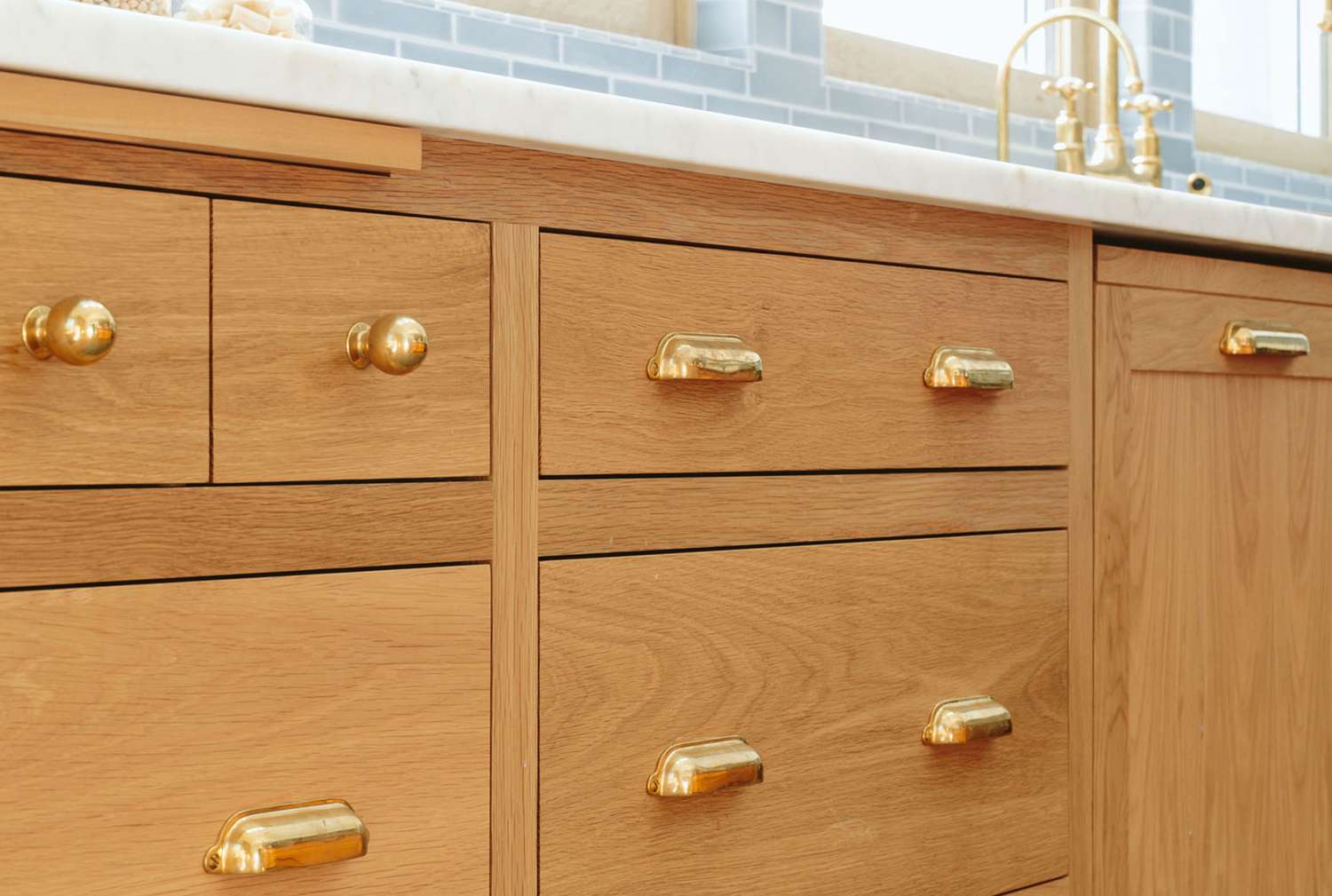 Kitchen cabinet with gold knobs and pulls