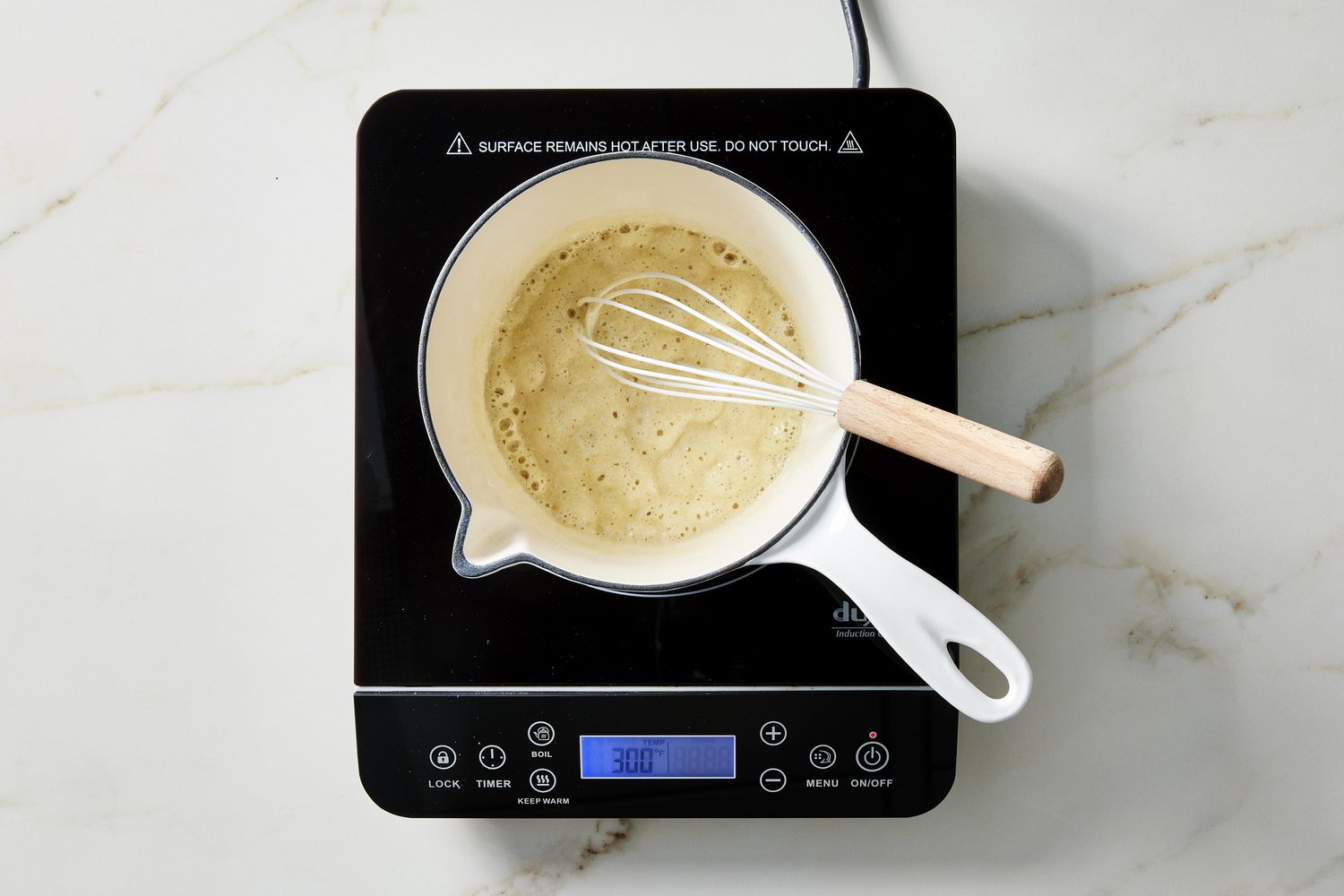 whisk and pot with flour 