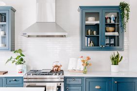 white kitchen with blue cabinets and white tile