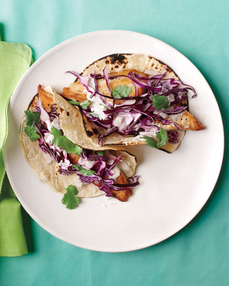fish tacos with red cabbage on white plate