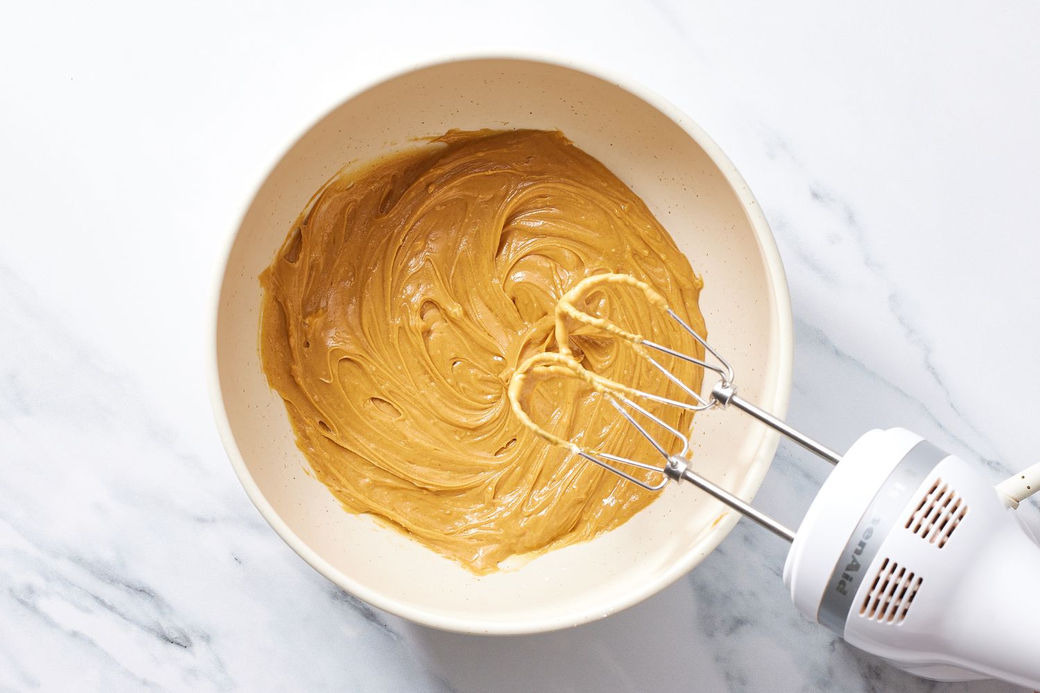 Filling in a bowl with mixer for peanut butter sandwich cookies