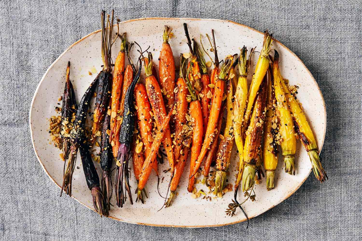A dish of roasted carrots sprinkled with dukkah seasoning