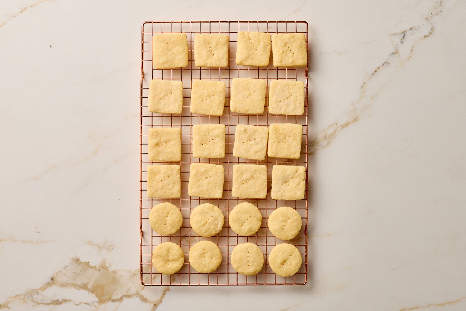 Cooling rack filled with square and round shortbread cookies