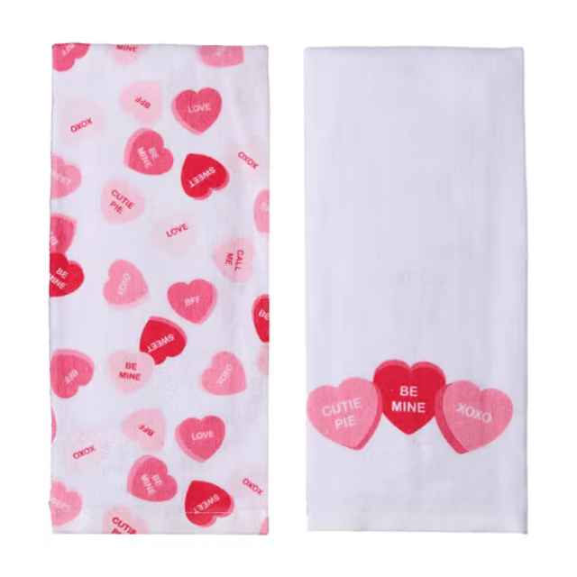 Two cloths with heartshaped candy designs and romantic phrases