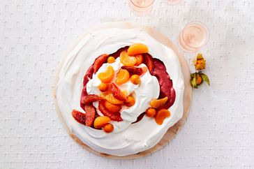 cranberry curd and citrus pavlova with sliced oranges