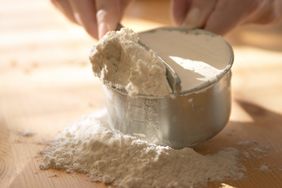 discarding extra flour from measuring cup