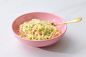 A bowl of creamy coleslaw with a fork