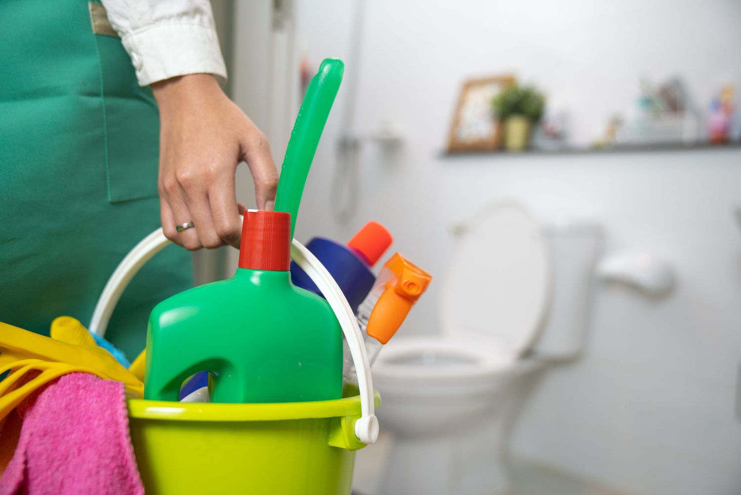 woman holding bucket with cleaning products